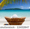 woman sunbathing in a teak chair on a beautiful Caribbean beach